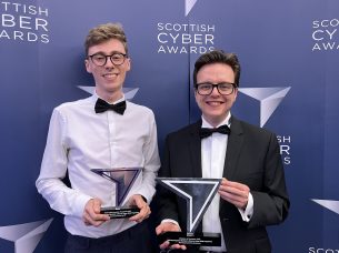 Craig and Daniel each holding a Scottish Cyber Award and smiling.