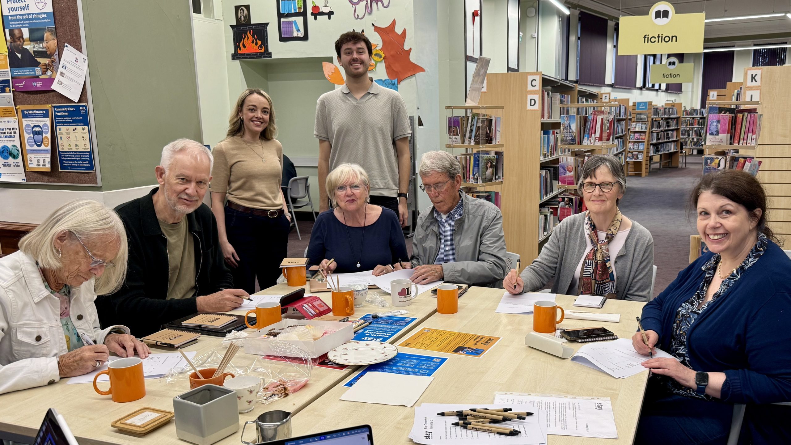Kirstie and Kieran with learners in a library
