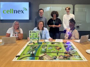 Daniel and Craig with volunteers from Cellnex UK around a table.